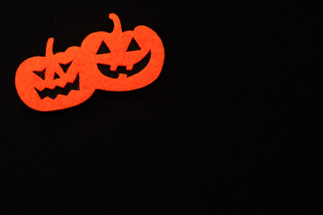felt orange halloween pumpkin on a black background. dark background for halloween