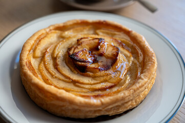 French fresh baked sweet puff pastry with fresh apple fruits in sirup  in confectionery shop