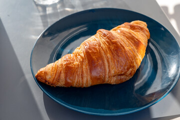Fresh baked buttered croissants served in restaurant for continental or French breakfast close up