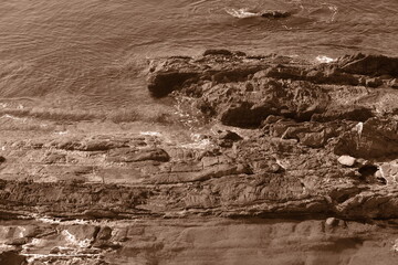 Summer sea waves. Rocks and reefs near shores. Sepia