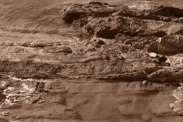 Summer sea waves. Rocks and reefs near shores. Sepia