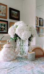 Nostalgic cozy breakfast nook with teapot and hydrangeas 