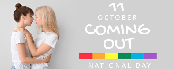 Young lesbian couple on grey background