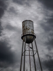 Old rusty water tower with stormy background