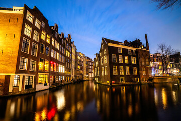 Obraz premium Amsterdam canal Singel with typical dutch houses during twilight, Holland, Netherlands.