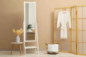 Large mirror near beige wall in bathroom. Interior design