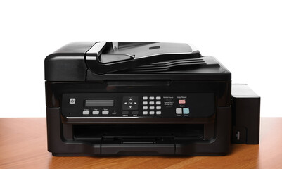 One modern printer on wooden table against white background