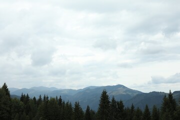Picturesque view of beautiful mountains under cloudy sky
