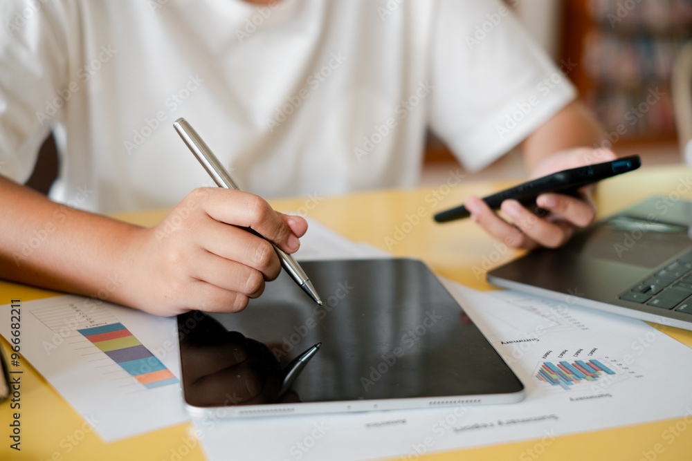 Poster close-up of hands using a digital tablet and smartphone, with graphs and a laptop on a desk, represe