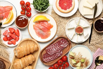 Different tasty food served for brunch on white marble table, flat lay