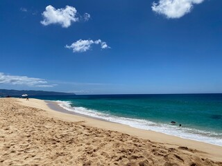Bright blue sky, ocean, white clouds