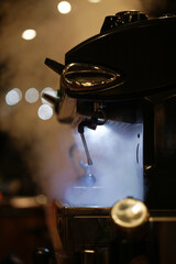 Naklejka premium Coffee machine in a steam at cafe