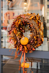 Halloween decorated outdoor cafe or restaurant terrace in America or Europe with autumn wreath traditional attributes of Halloween. Frontyard decoration for party. 