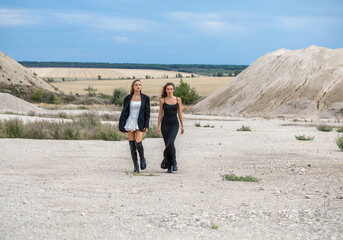 Full length portrait of a young beautiful girls in sand quarry