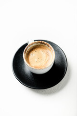 Cup of coffee on bright wooden background. Soft focus. Close up. Copy space.	