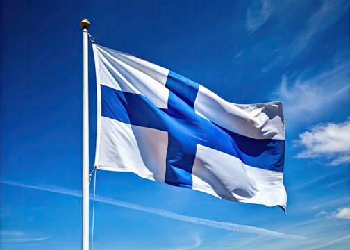 A majestic blue Nordic cross flag with a white Scandinavian cruciform design waving proudly in the wind against a clear blue sky in Finland.