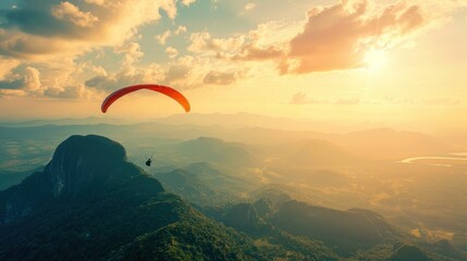 Paragliding Over Mountains at Sunset.