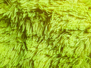 Soft pillowcase texture made of wool yarn. Light green background