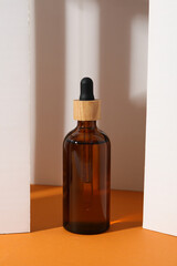 Cosmetic oil in a brown bottle with a wooden cap