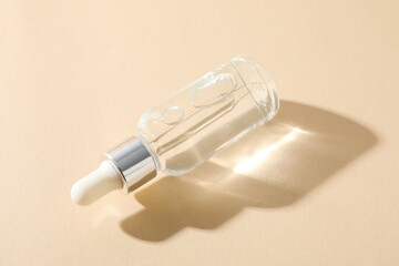 Cosmetic oil in a transparent bottle on a light background