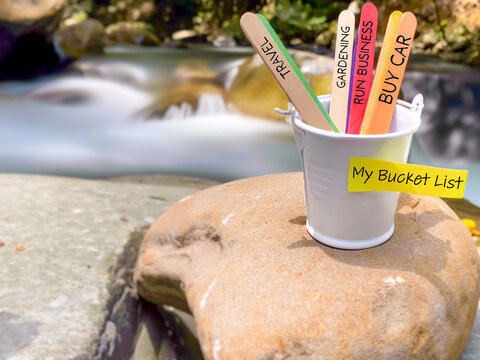My bucket list text on adhesive notepaper with nature background. Stock photo.