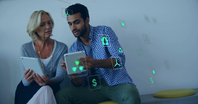 Image of eco icons and data processing over diverse business people in office