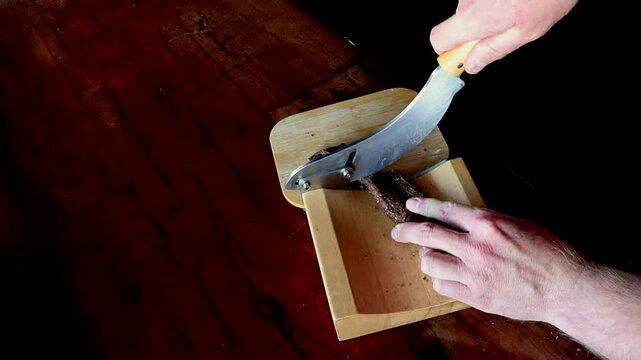 Biltong being sliced thinly in a South African kitchen, a traditional favourite, better then beef jerky and part of South Africas heritage