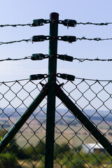 Close-up view of fencing that is made of steel wire. A device that prevents the entry of strangers and animals.