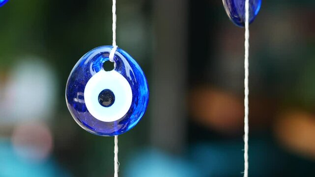 a blue evil eye keychains hanging on a shelf