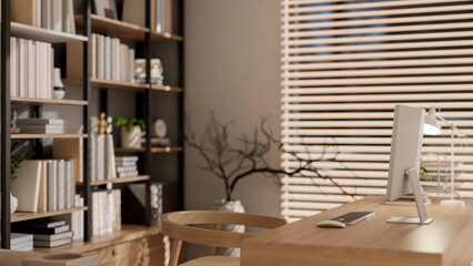 A side view of a minimalist wooden computer desk in a cozy, contemporary office or home office.