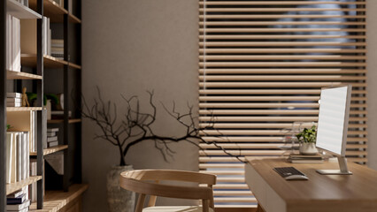 A side view of a minimalist wooden computer desk in a cozy, contemporary office or home office.