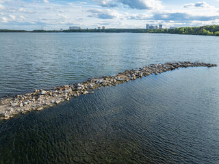 Aerial view of lake or river green shore with forest. Summer season.