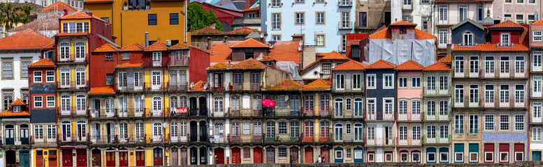 Panoramic view of UNESCO world heritage site Porto city in Portugal with row of several colorful historic buildings.