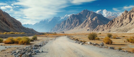 A Dusty Road Winding Through a Mountainous Valley
