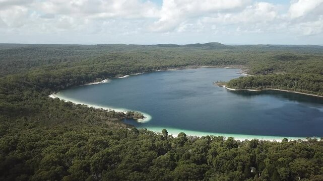 4k footage of low angle aerial drone fast flight over Lake Allom, one of the famous fresh water lakes Fraser Island, Queensland, Australia.The lake is popular for its freshwater turtles.