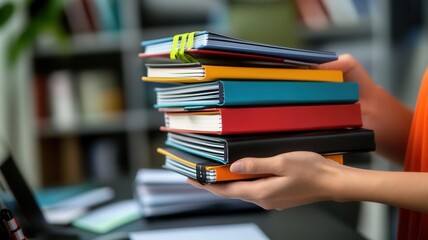 Hands holding branded notebooks stacked on a desk, Office Supplies, Distributing branded materials to the office team