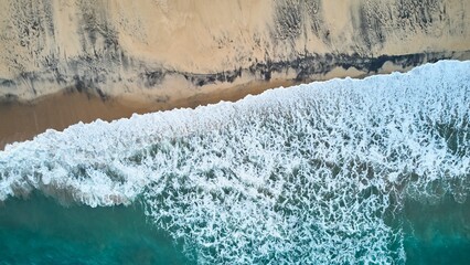 Aerial view of an emerald green sea and big foaming waves. Indian Ocean. Dikwella beach. Sri Lanka. High quality photo