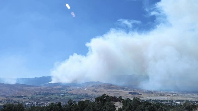 Time lapse of Davis wildfire from the Geiger grade overlook. People come and go taking photos from a rock with high vantage point