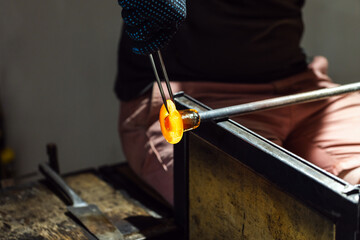 Molding molten glass, glass blowing workshop