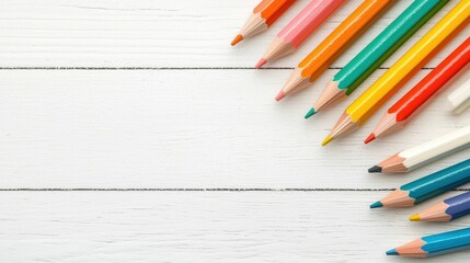 Obraz premium Colorful Pencils on White Wooden Background with Copy Space
