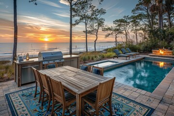Fototapeta premium Coastal outdoor dining area with aluminum grilling station, wooden table and chairs on blue-green patterned rug, overlooking the ocean in Beagan, South Carolina, with beach pine trees and pool reflect