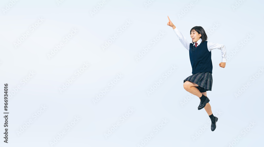 Aufkleber 空を指さして目標に向かってジャンプする女子学生の全身写真（切り抜き背景透過pngも販売しております。作成者リンクから「png」で検索してください）