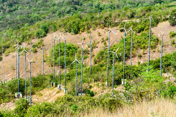 Wind power on the mountain and blue sea on a clear sky background morning day at Koh Larn island. View point on mountain to see view of windmill and sky. Wind turbine. Wind Energy. Pattaya, Thailand.