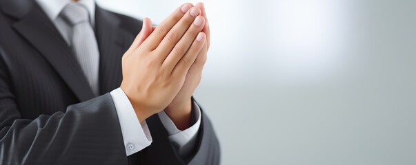 Obraz premium A professional man demonstrates a gesture of gratitude and respect in a formal setting during a business meeting