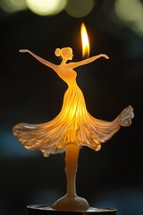 Fototapeta premium A beautiful ballerina candle with a flickering flame.
