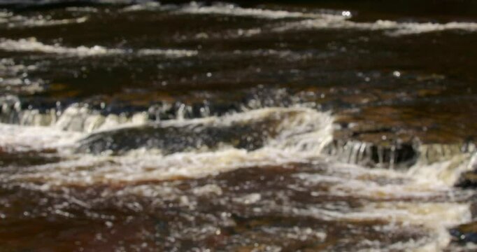 Out of focus shot of the river ure going over rocks at Aysgarth falls, Yorkshire dales