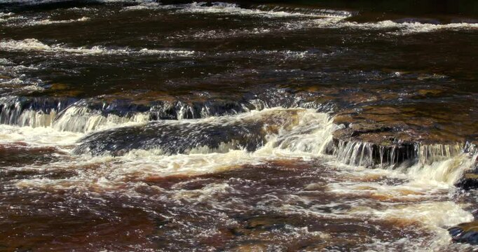 shot of the river ure going over rocks at Aysgarth falls, Yorkshire dales