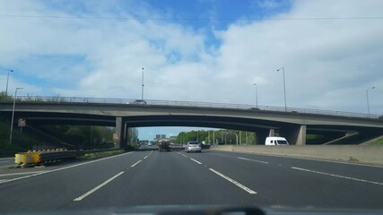 Low Angle Footage of British Motorways Travel by Car During Cloudy Day. Front Windscreen Footage was Captured on April 20th, 2024