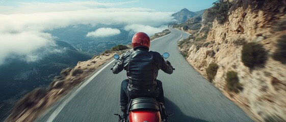 Riding motorcycle on winding road, rider enjoys thrilling view of mountains and clouds. sense of freedom and adventure is palpable in this scenic landscape