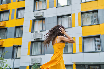 Chic woman in yellow at modern building